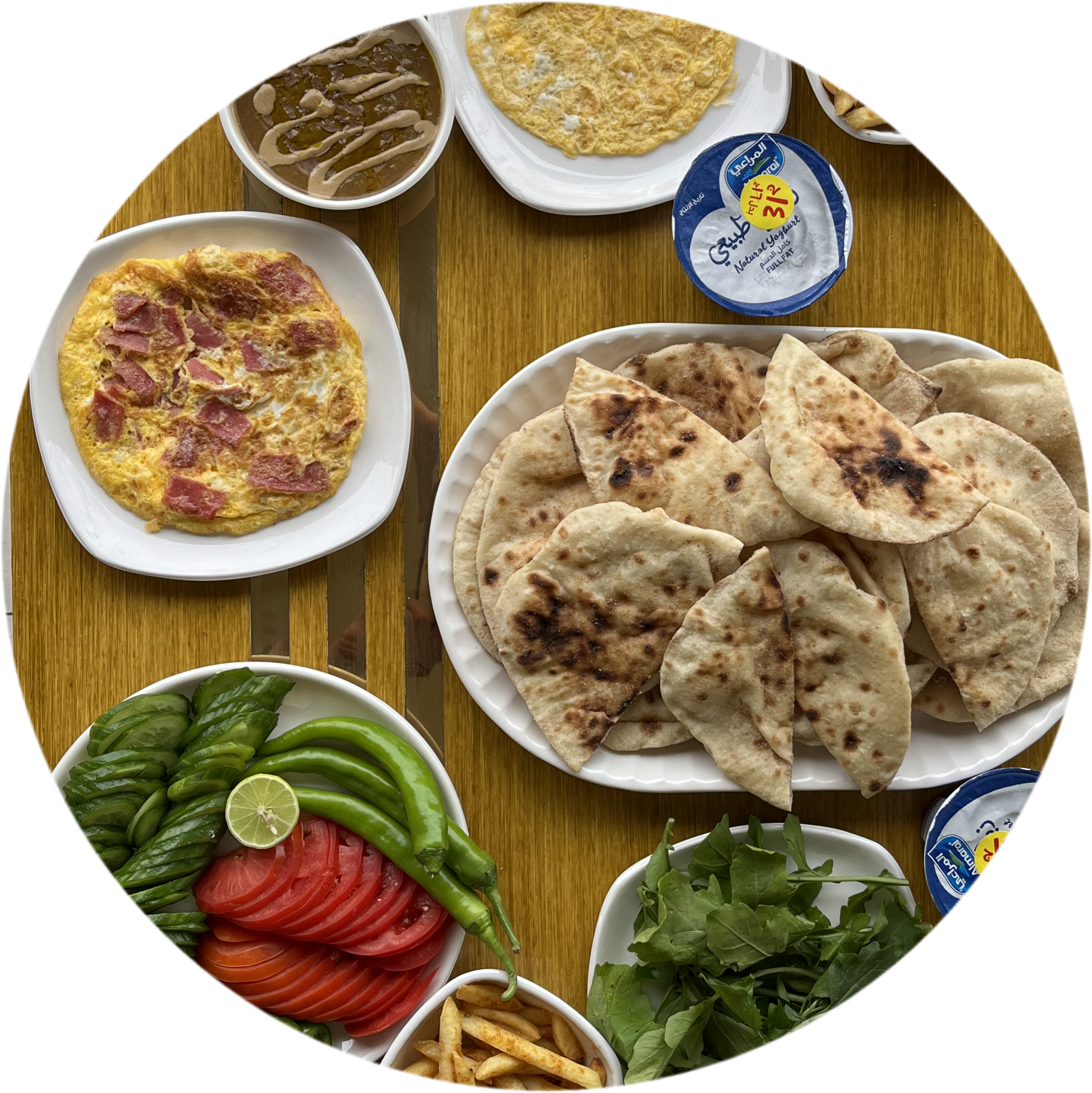 large breakfast (2 plates of fava beans - 2 plates of eggs - a plate of potatoes - vegetables - a plate of cheese with tomatoes - bread - pickles)